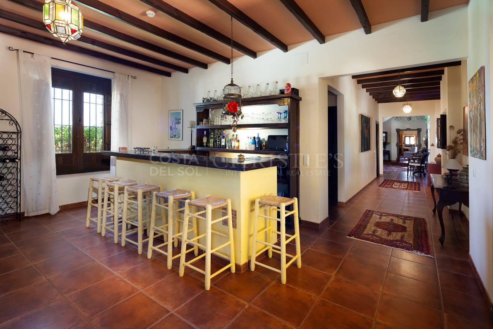 A comfortable living room, bar, dining room and terrace